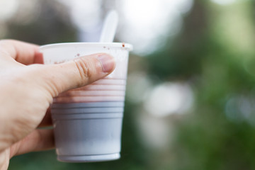 plastic cup with hot chocolate on the outside