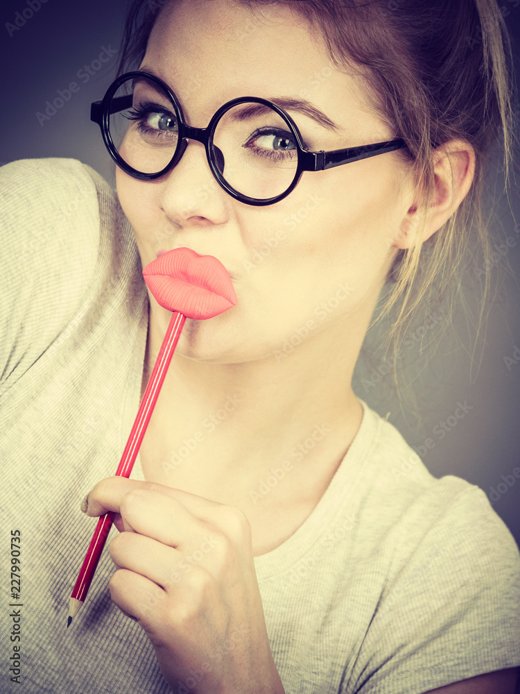 Poster Happy woman holding fake lips on stick