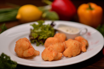 cauliflower in batter on a white plate