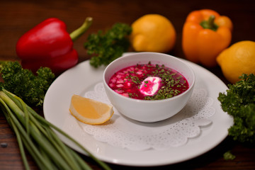 beet soup, beetroot soup in a white plate with lemon