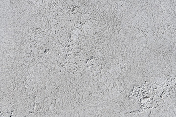 Gray textural background. Relief plaster. Fashionable background of natural concrete or cement with black splashes.