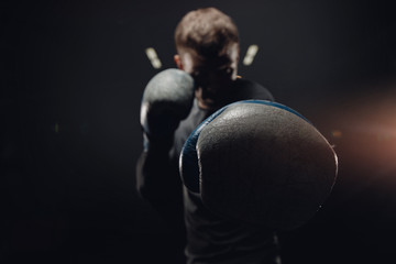 Portrait muay thai silhouette boxer man in gloves against dark background. Concept training boxing. - obrazy, fototapety, plakaty