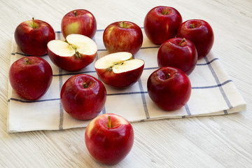 Fresh raw red apples on white wooden table, side view. Close-up.