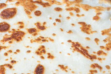 Von fried the surface of the pancake close up. Photo format horizontal