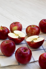 Fresh raw red apples on white wooden background, side view. Close-up.