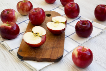 Fresh raw red apples on white wooden background, side view. Closeup.