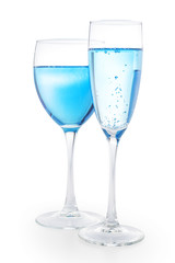 Two drinking glasses with blue liquid isolated with clipping path