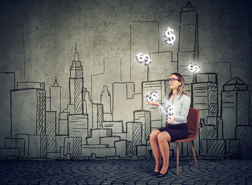 Businesswoman juggling with dollar symbols on a cityscape background