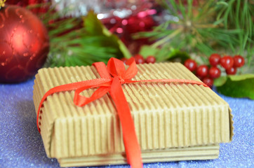 Fototapeta na wymiar Gift boxes with a large red bow against a background bokeh of twinkling party lights. Luxury New Year gift. Christmas gift. Christmas background with gift box. Christmastime celebration