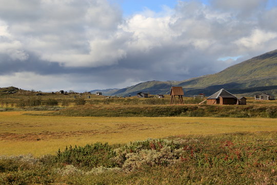 A sami village in the mountains under cloudy sky