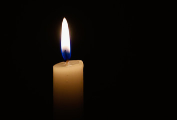 candle lit in darkness with high detail and focus.