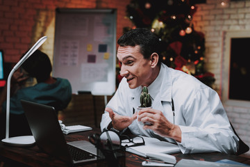 Young Doctor in Uniform in Office on New Year Eve.