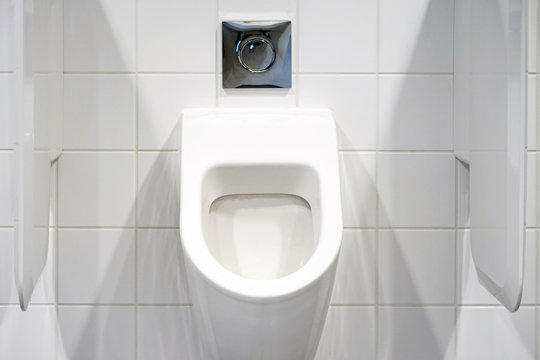 Close-up of toilet bowl. White toilet in the bathroom. Public toilet in the airport or restaurant, cafe.
