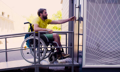 Young disable man in wheelchair going to a public restroom