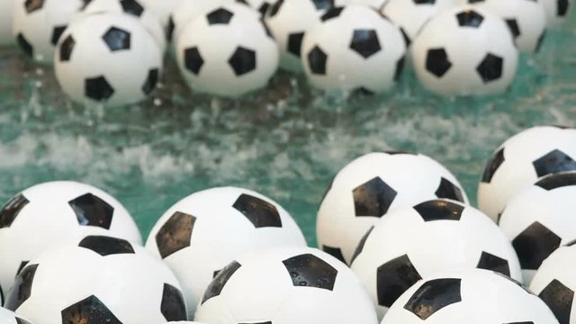 Many Black and White Soccer Balls Background. Football Balls Swimming in a Pure Water
