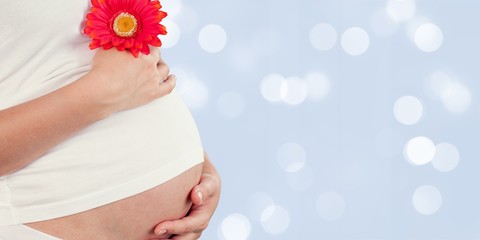 Pregnant woman in dress with red flower