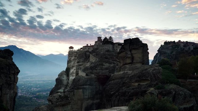 Scenic sunset dark evening sky over holy Varlaam monastery on cliff in Meteora, Thessaly Greece. Greek destinations. Time lapse
