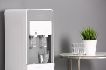 Modern water cooler in stylish office interior