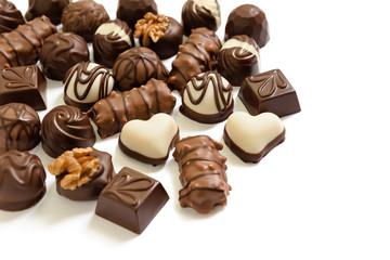 Assortment of chocolate candies from black, milk and white chocolate with nuts and marzipan