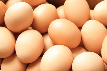 Pile of raw brown chicken eggs, closeup