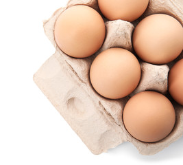 Carton of raw chicken eggs on white background, top view