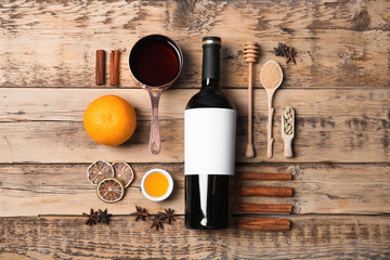 Flat lay composition with ingredients for mulled wine on wooden background