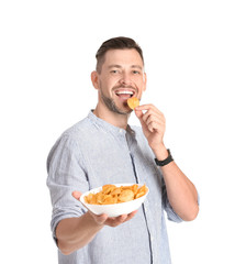Man eating potato chips on white background