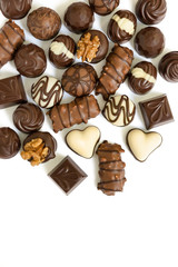 Assortment of chocolate candies from black, milk and white chocolate with nuts and marzipan