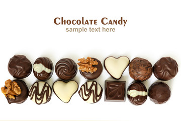 Assortment of chocolate candies from black, milk and white chocolate with nuts and marzipan