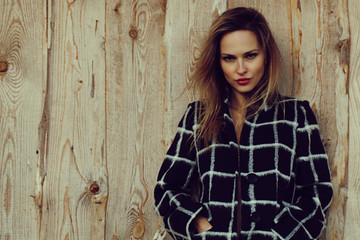 Fototapeta premium season and people concept - Autumn portrait of girl. Outdoor beauty portrait woman, fashion model, street style. wood background.