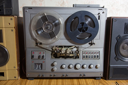 Old reel-to-reel recorder with magnetic tape on it