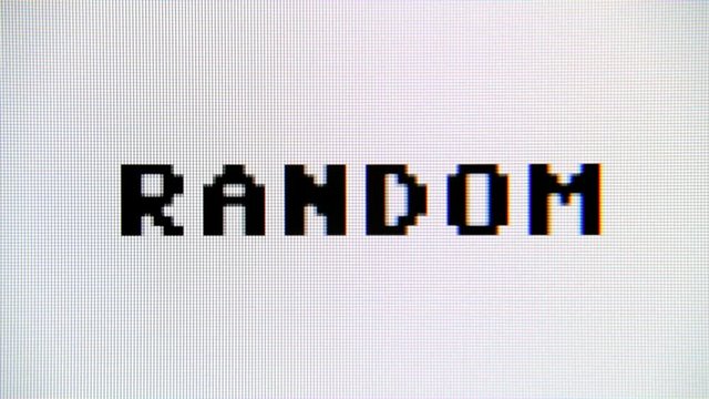 Typing the word Random on a computer monitor. Macro detail shot.
