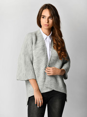 Young beautiful woman posing in new casual grey blouse sweater and shirt