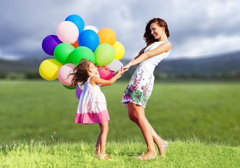Beautiful happy mother with daughter having fun