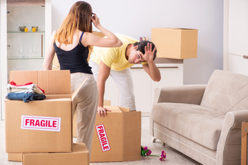 Young couple moving to new flat with fragile things