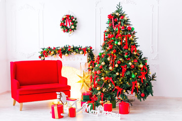 a bright room with a beautiful Christmas tree, a fireplace and a red sofa