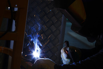 Industrial Worker at the factory welding macro