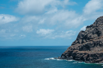 black rock mountain at coast - cliff at ocean coast  -