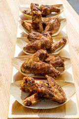 Portion of chicken wings grilled in trays