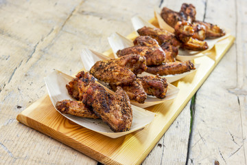 Portion of chicken wings grilled in trays