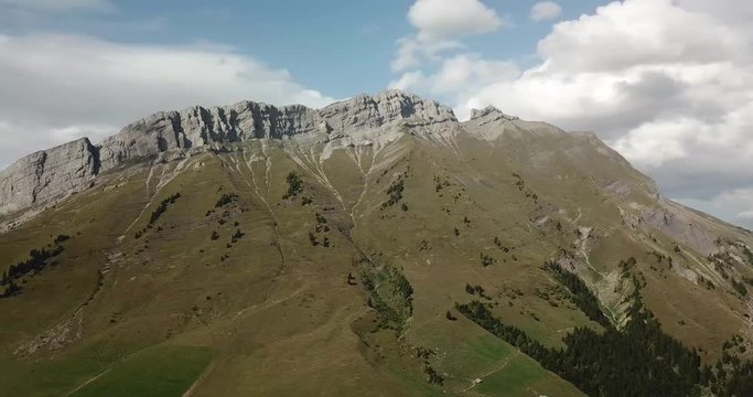 Panning aerial view of the col des Aravis in the french alps on a sunny day