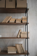 Book shelf with empty space on concrete background, loft interior