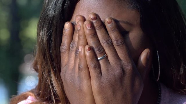Desperate sad african young woman crying- close up- outdoor