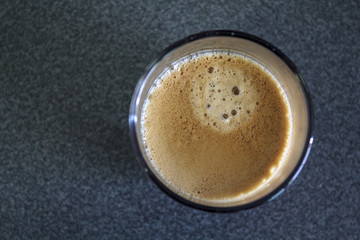 Obraz na płótnie Canvas Espresso coffee with foam, top view