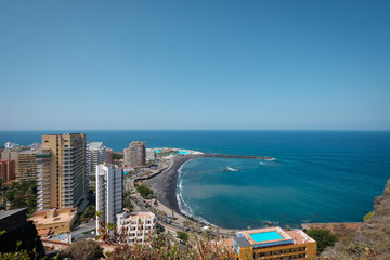 Obraz na płótnie Canvas City and beach aerial of Puerto de la Cruz with ocean horizon background