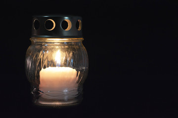 White votive candle lantern on dark background - obrazy, fototapety, plakaty