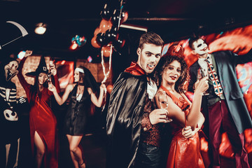 Young Happy Couple in Costumes at Halloween Party