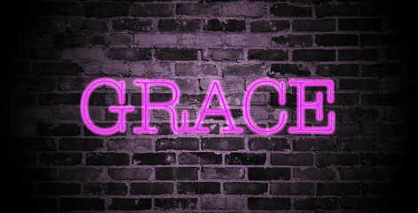 first name Grace in pink neon on brick wall