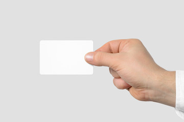 Obraz premium Mockup of male hand holding a Business Card isolated on light grey background. Rounded corner, Europe standard size 85×55 mm.