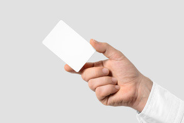 Mockup of male hand holding a Business Card isolated on light grey background. Rounded corner,...